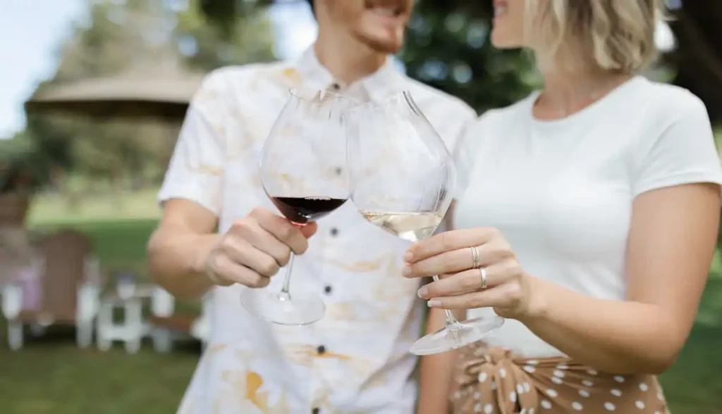Couple toasting with red wine under the camphor tree