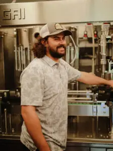 Micah Mossman at the winery bottling equipment