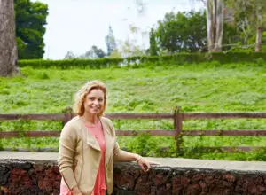 Paula Hegele of MauiWine at the ranch fence