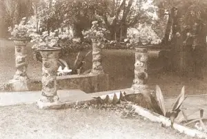Historic photo of the stone gate and gardens at Rose Ranch