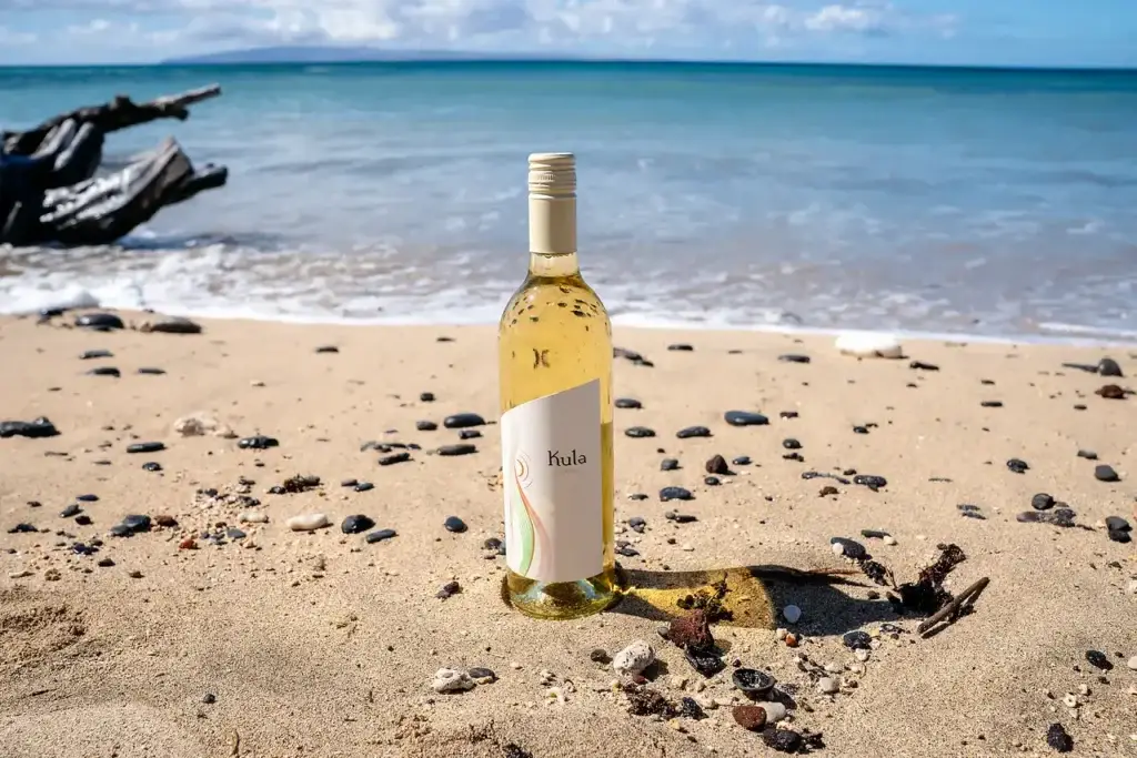 Bottle of Kula white wine on a sandy Maui beach