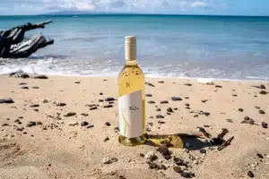 Bottle of Kula white wine on a sandy Maui beach