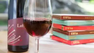 Bottle and glass of Lehua raspberry wine with chocolate bars