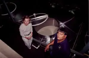 Historic photo of winemakers checking a tank of fermenting wine