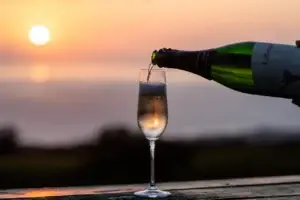 Lokelani sparkling rosé being poured into a flute at sunset