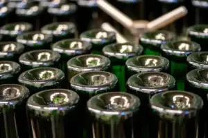 Sparkling wine bottles in a crate during production