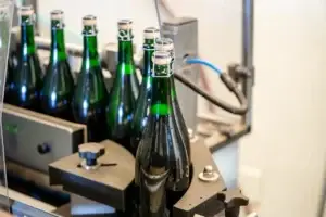 Sparkling wine bottles on the corking line
