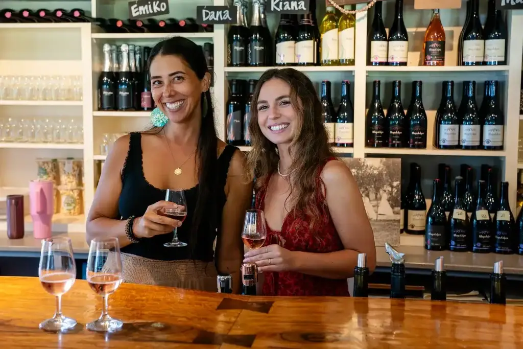 Two guests enjoying wine at the tasting room bar