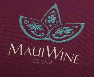 MauiWine logo embroidered in teal and cream on burgundy fabric
