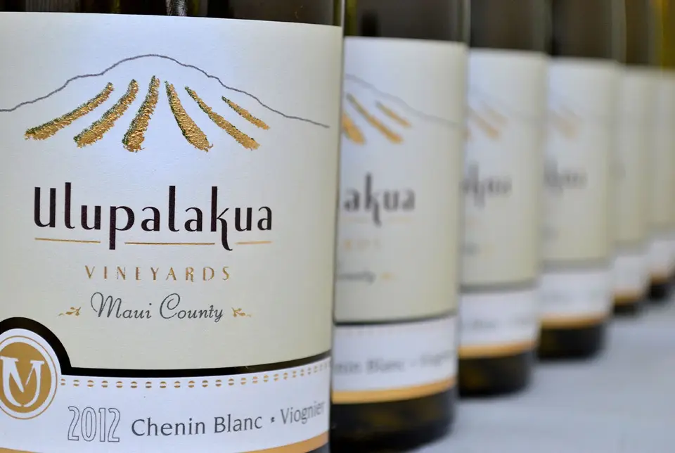 Row of Ulupalakua Vineyards estate wine bottles with Chenin Blanc in front