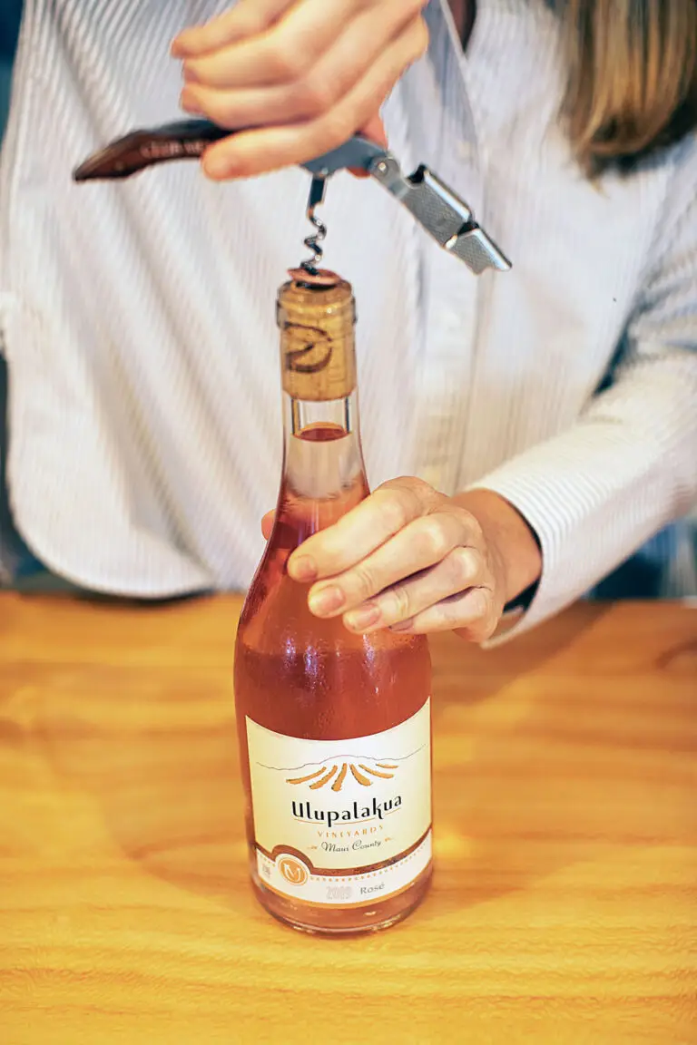 Opening a bottle of Ulupalakua Vineyards Rosé with a corkscrew